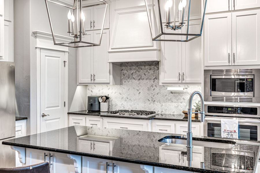 White kitchen with a large granite island